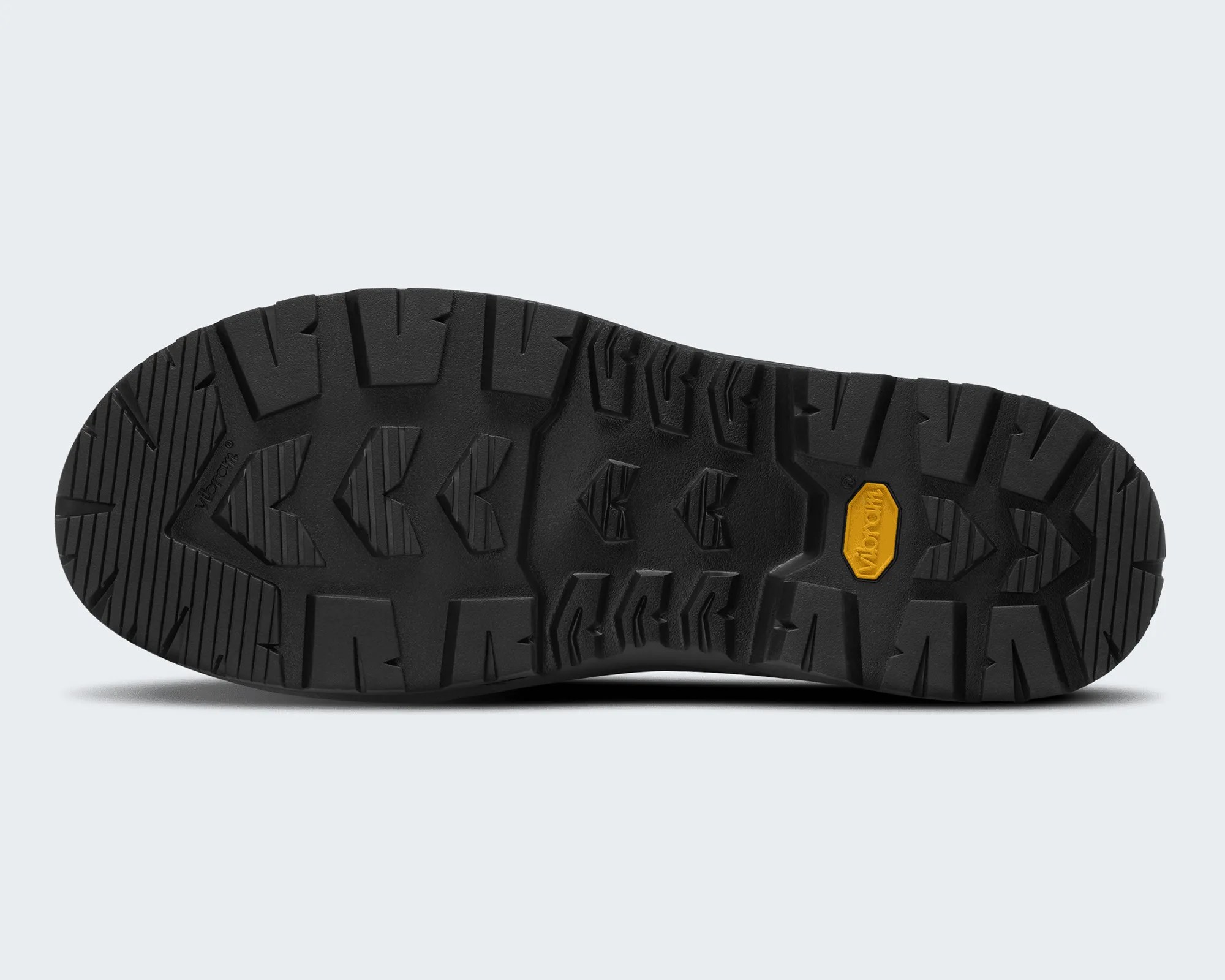 Black Vibram rubber outsole with deep treads and a yellow Vibram logo patch.