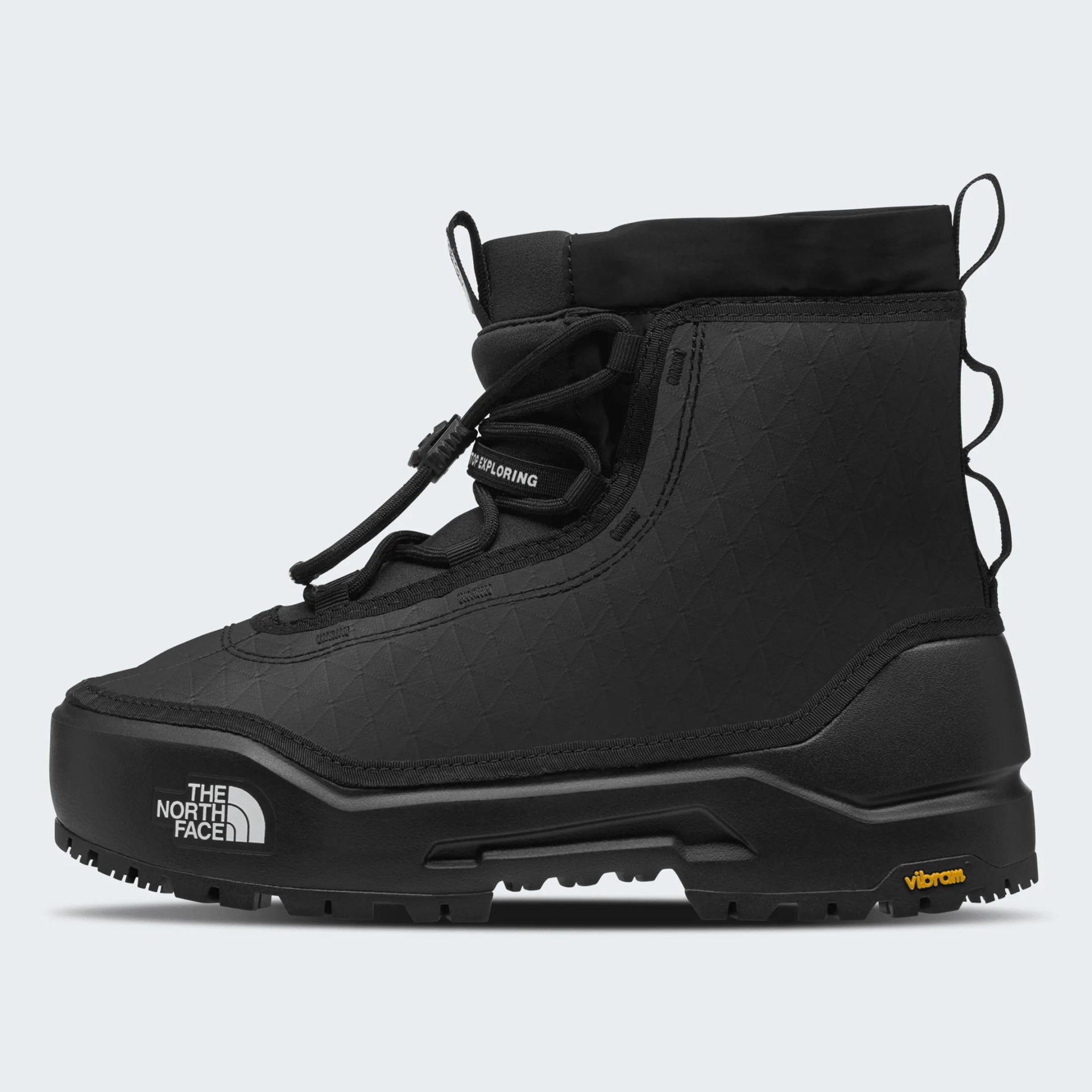 Black high-top hiking boot with The North Face logo on the sole and Vibram branding on the heel.