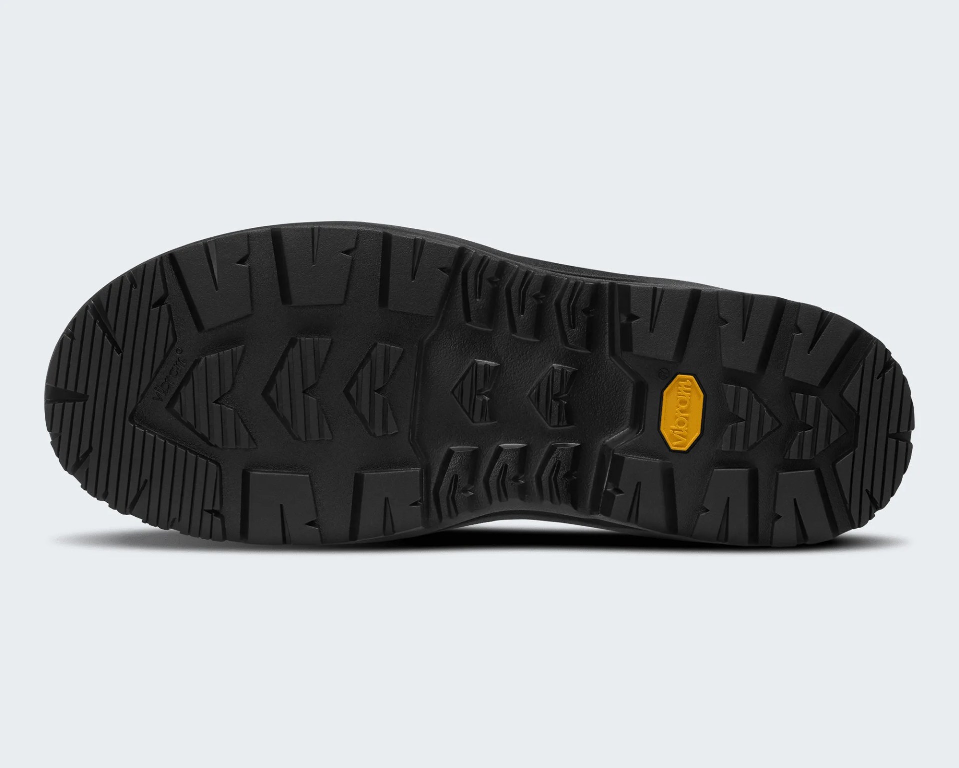 Black Vibram rubber outsole with deep treads and a yellow Vibram logo patch.