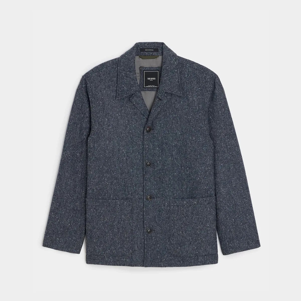 Dark gray herringbone wool jacket with four buttons and a notched collar laid flat.