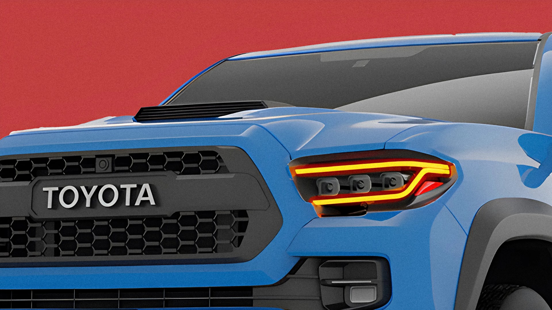 Front view of a blue Toyota truck with black grille and illuminated LED headlights against a red background.