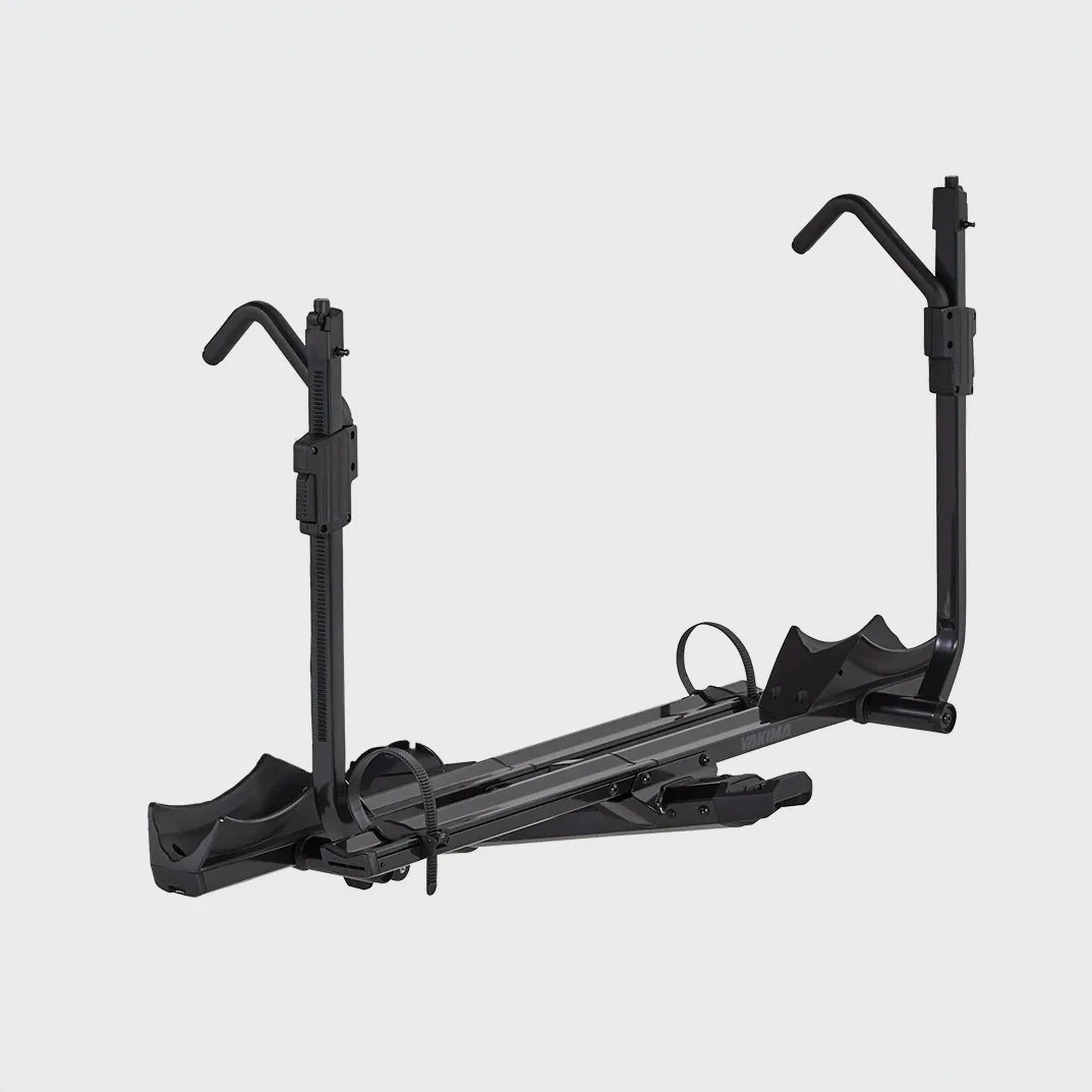 Black metal hitch-mounted bike rack with wheel holders and adjustable arms.