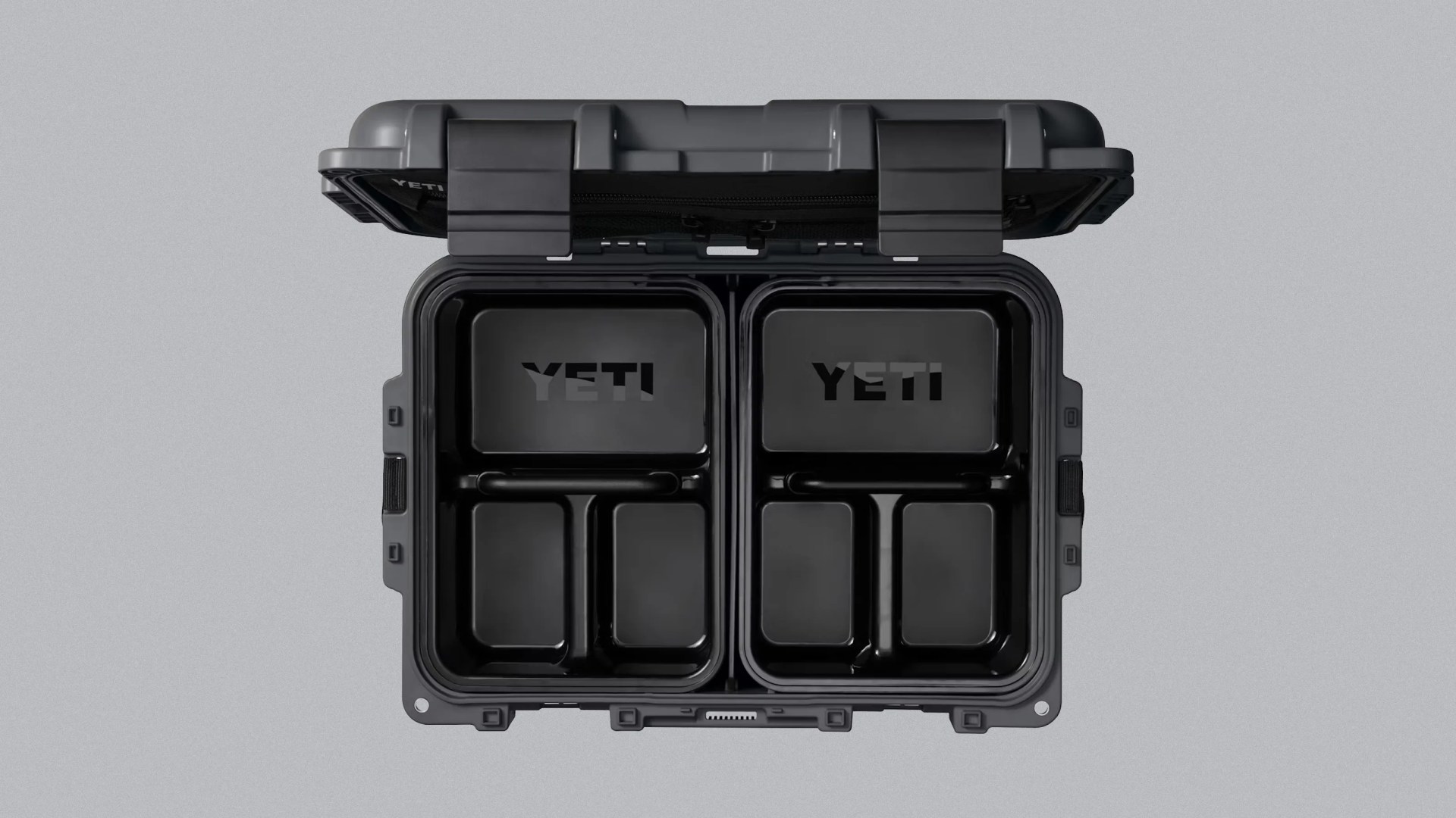 Open black YETI cooler with two removable black trays inside, each with compartments.