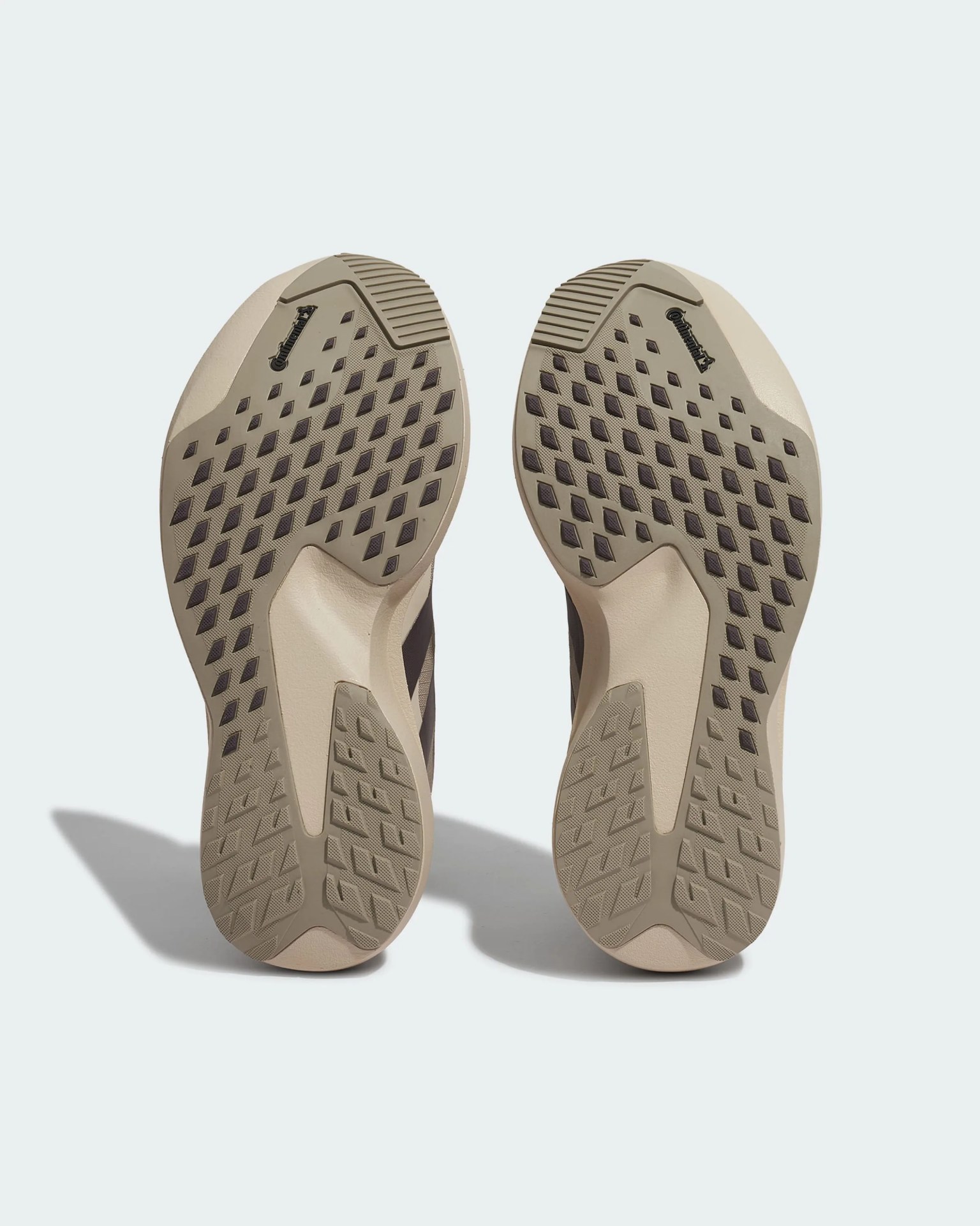 Beige shoe soles with diamond and rectangular tread patterns and Continental logo near the toes.