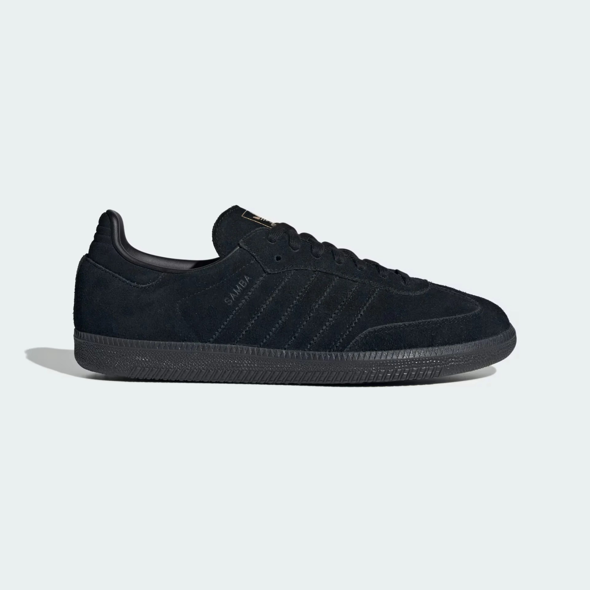 All-black suede Adidas Samba sneaker with black rubber sole and black laces on a light background.