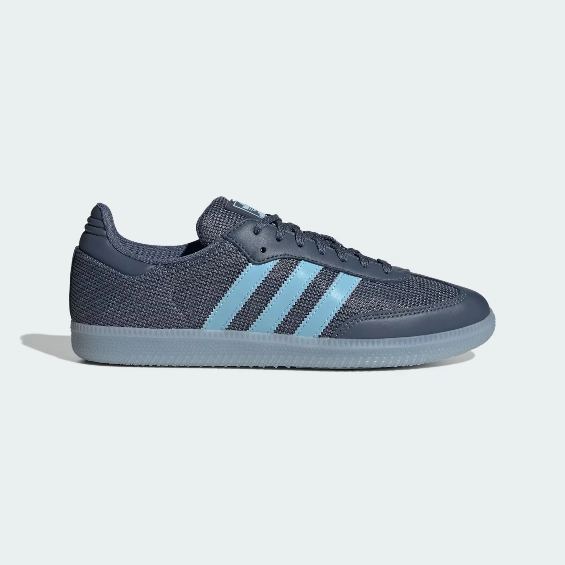 Dark gray Adidas sneaker with light blue stripes and a translucent rubber sole, shown from the side.
