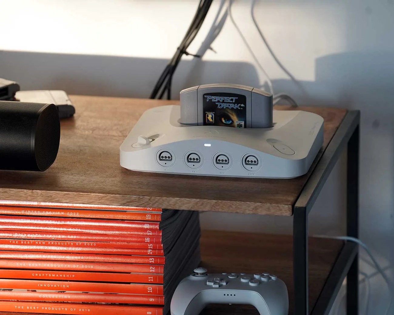 White retro gaming console with four controller ports and a 