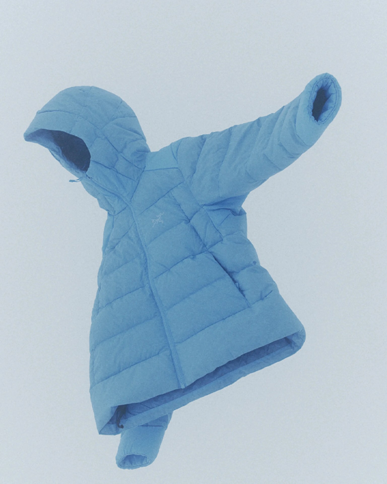 Light blue quilted hooded jacket with a front zipper and long sleeves.