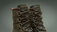 Pair of dark brown Sorel leather boots with thick brown laces and metal eyelets.