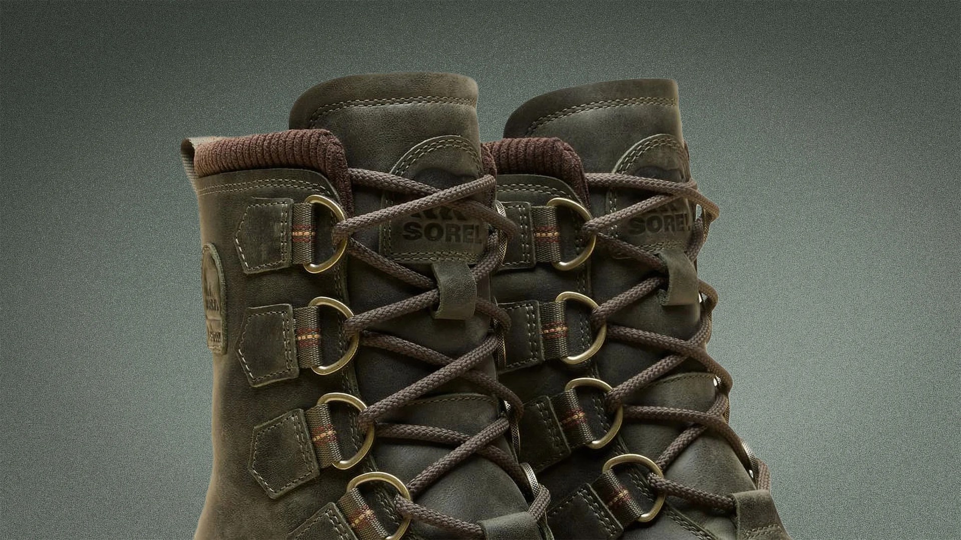 Pair of dark brown Sorel leather boots with thick brown laces and metal eyelets.