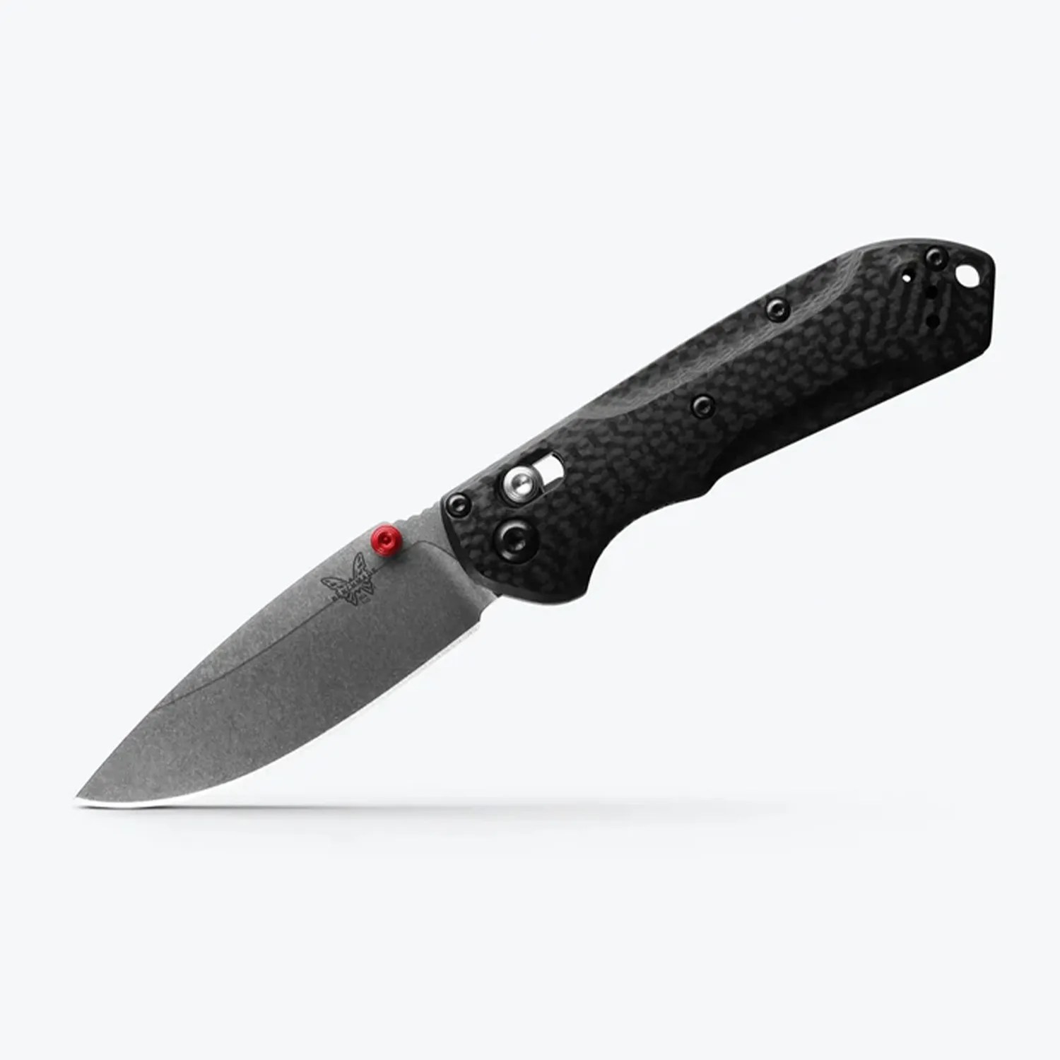 Folding knife with a stonewashed blade, red thumb stud, and black textured handle.