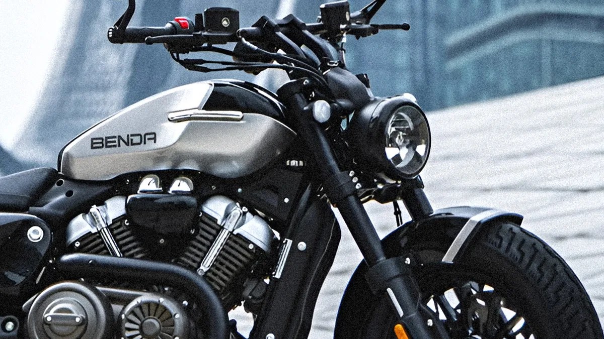 Silver and black Benda motorcycle with a round headlight and visible engine details.