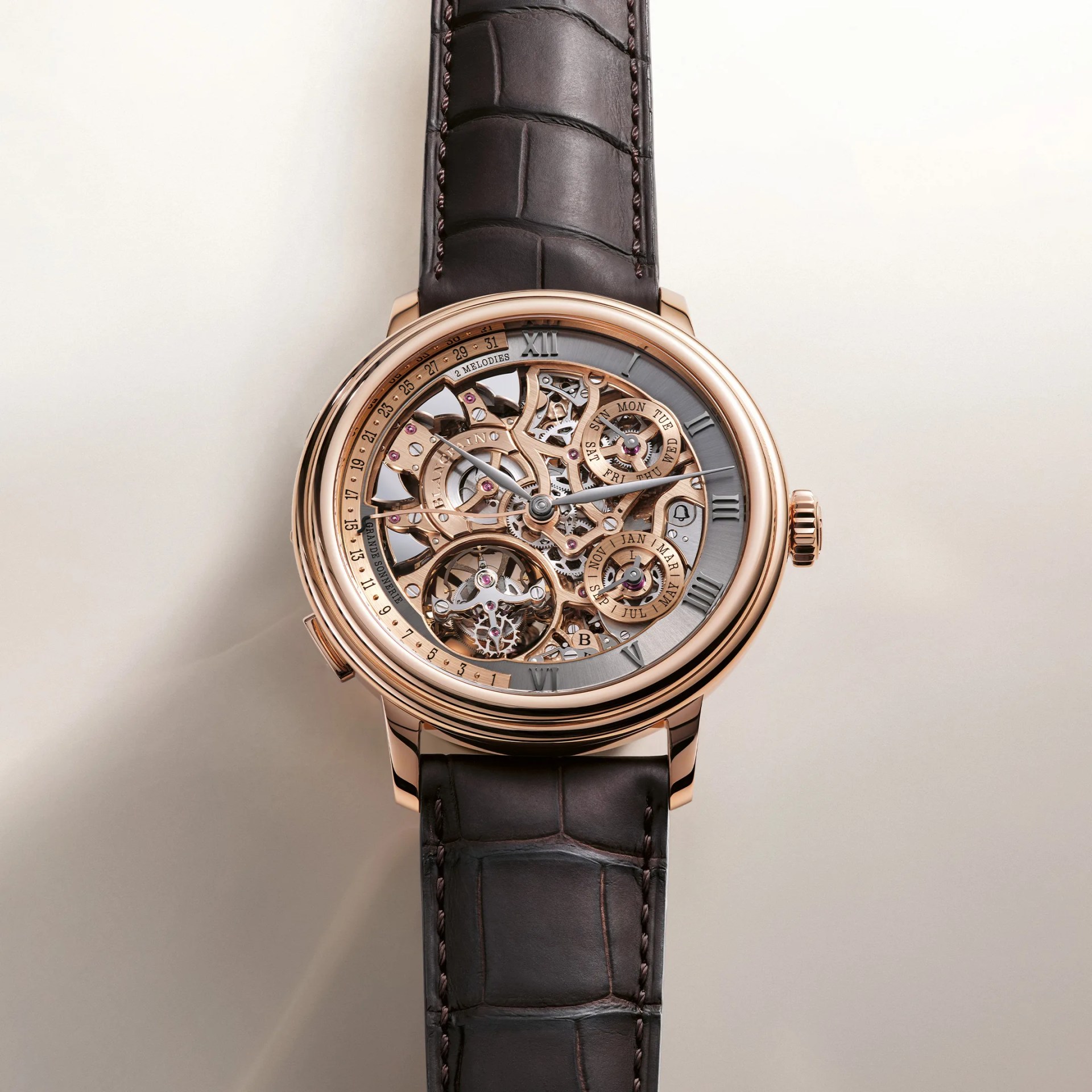 Skeleton dial wristwatch with rose gold case and brown alligator leather strap.