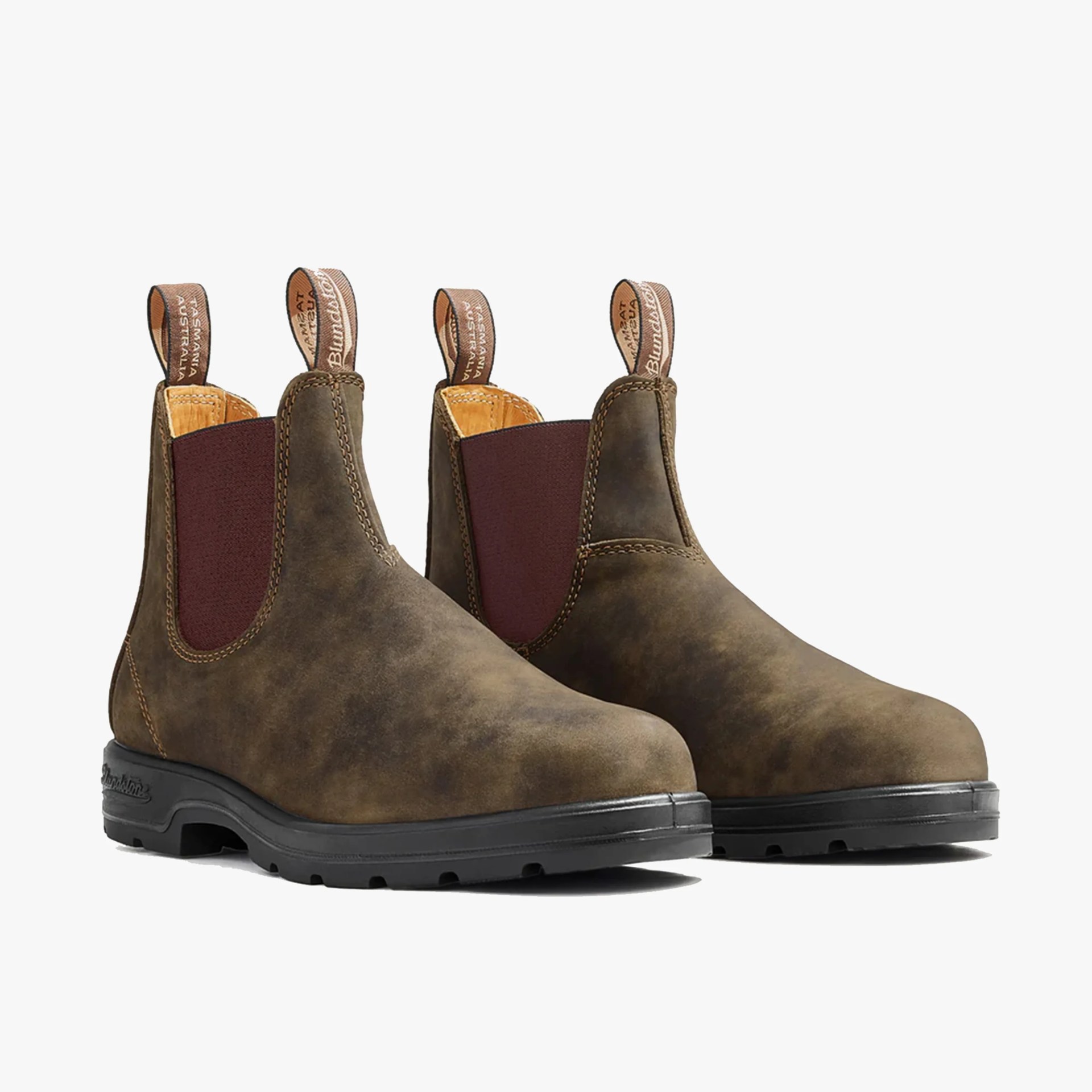 Pair of brown leather Chelsea boots with black rubber soles and maroon elastic side panels.