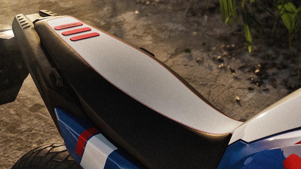 Close-up of a motorcycle seat with a white top, black sides, and three red rubber strips near the rear.