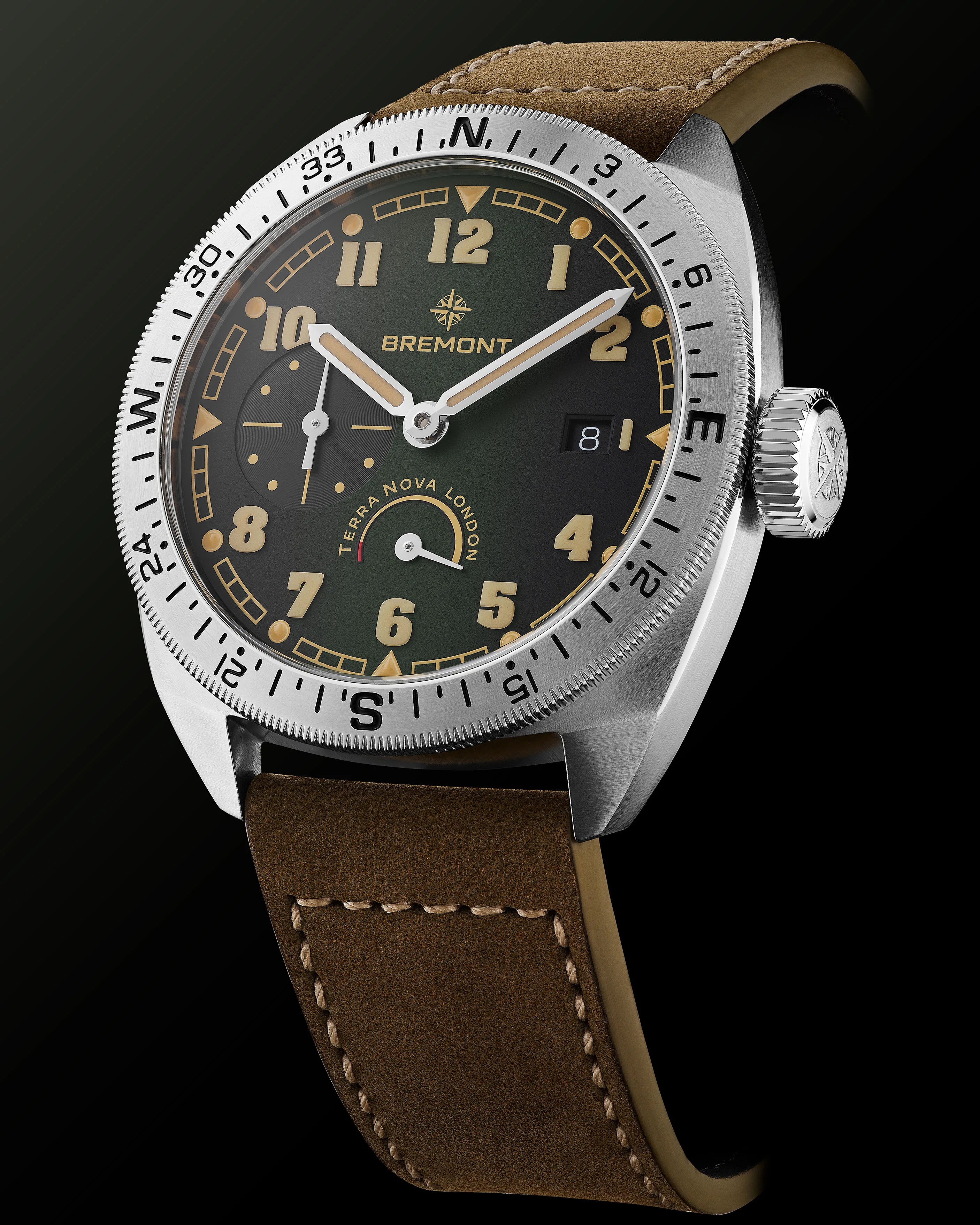 Stainless steel Bremont wristwatch with black dial, beige numerals, compass bezel, and brown leather strap.