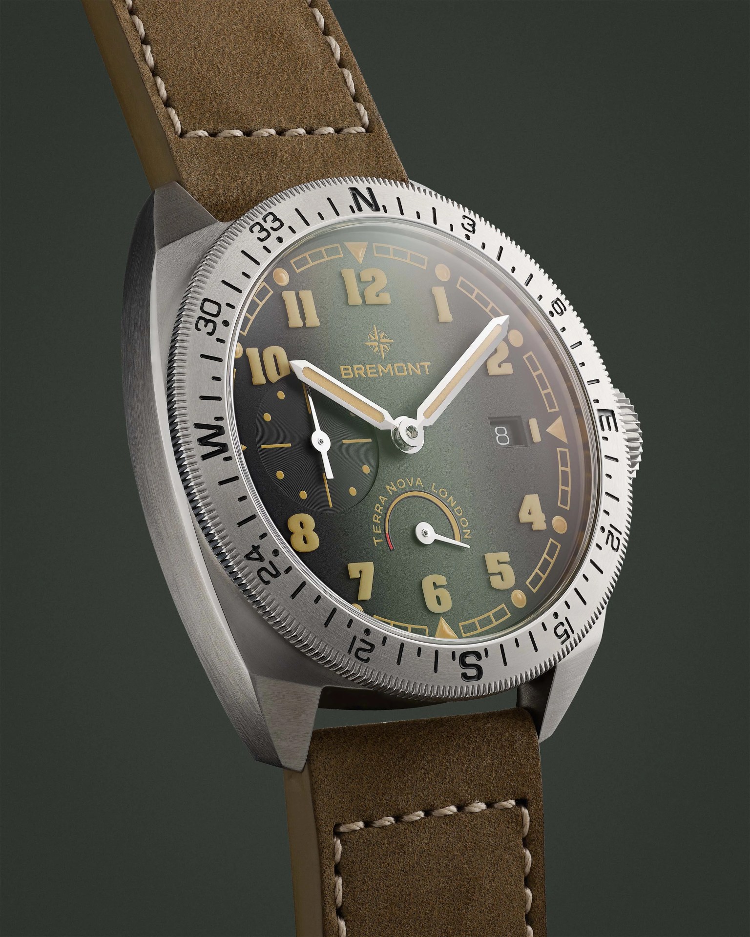 Stainless steel Bremont Terra Nova London watch with green dial, beige numerals, and brown stitched leather strap.