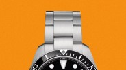 Stainless steel dive watch with black bezel and black dial featuring round and triangular hour markers.