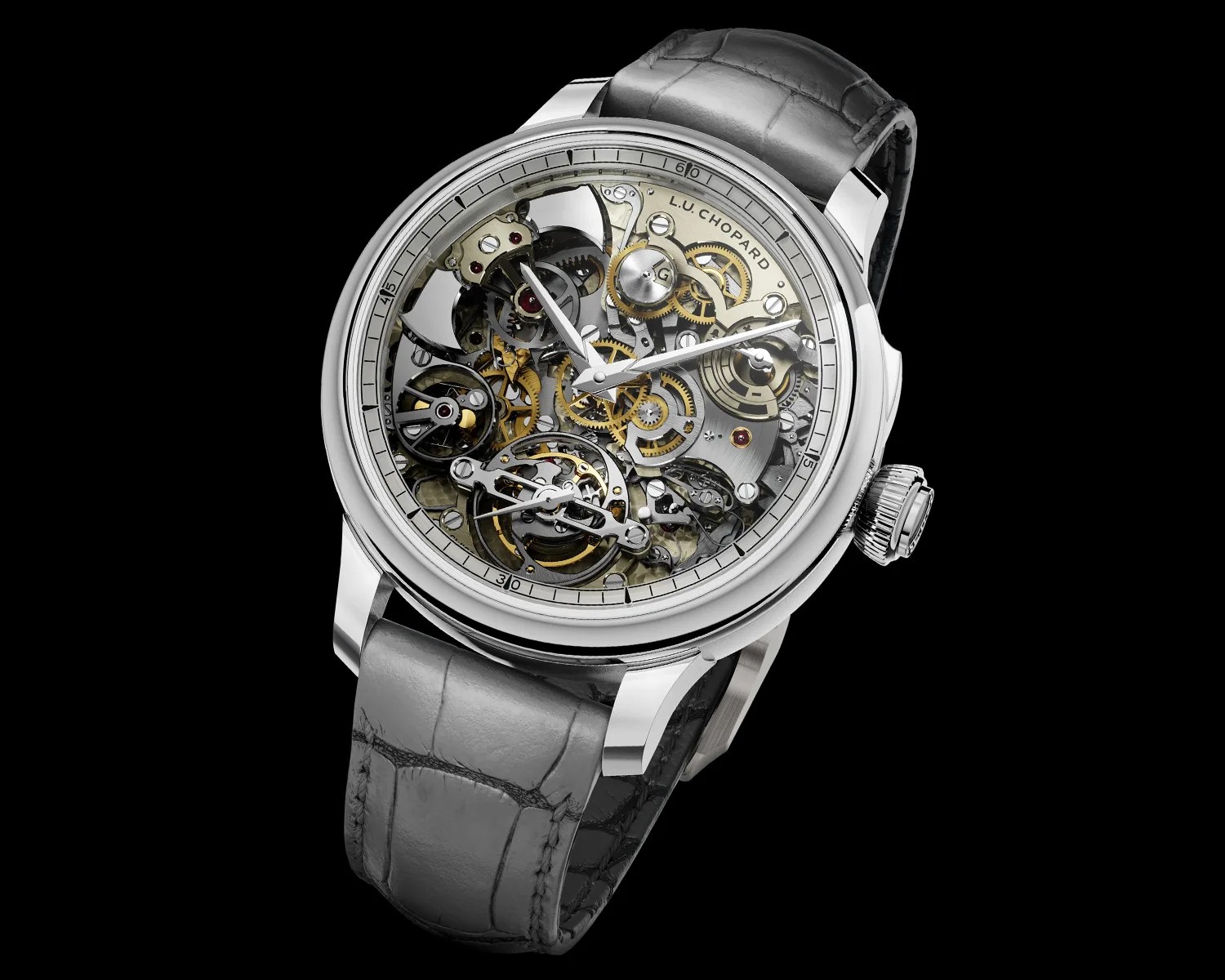 Silver mechanical wristwatch with visible intricate gears and a gray leather strap on a black background.