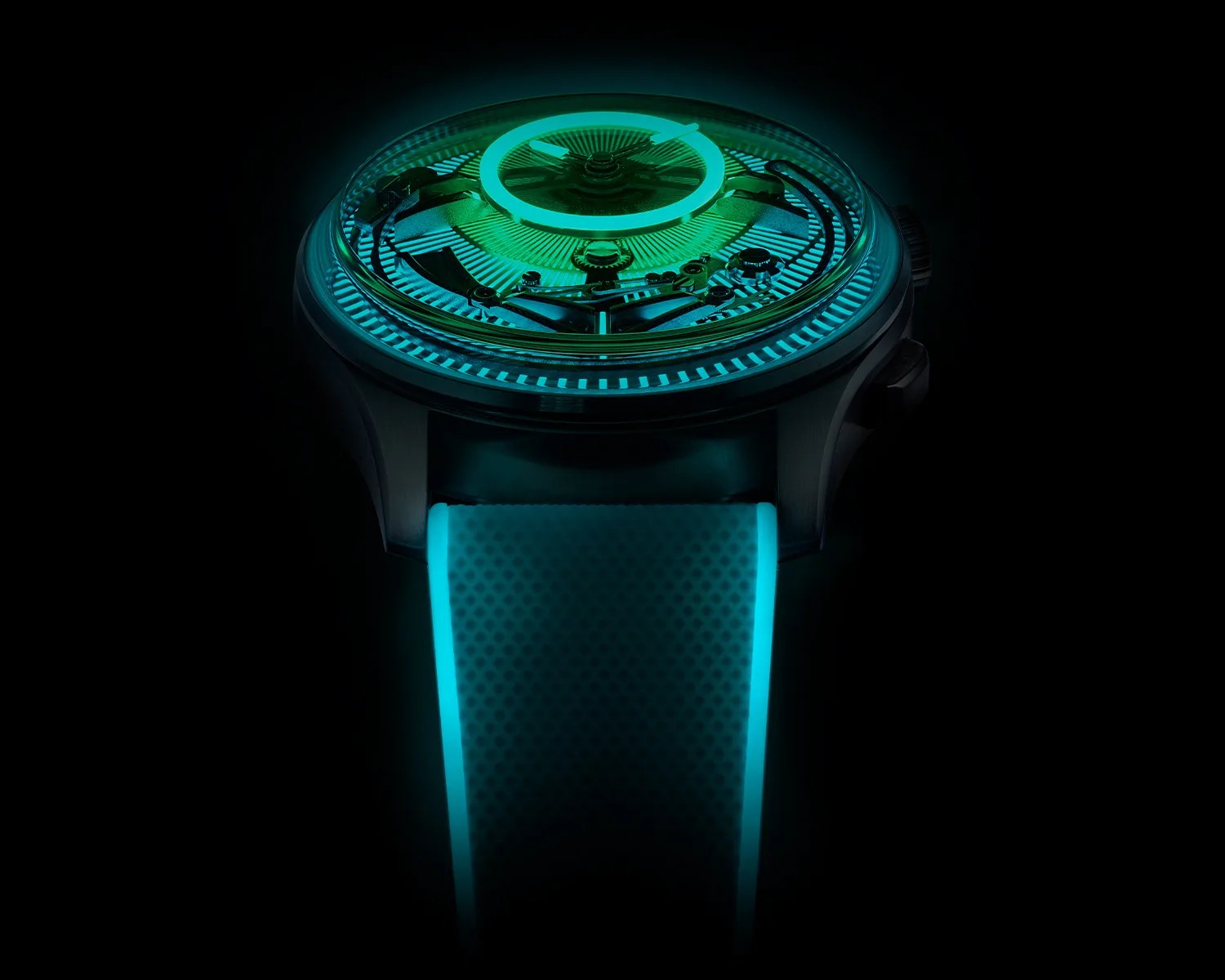 Black wristwatch with glowing turquoise luminescent dial details and matching textured strap edges in darkness.