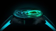 Side view of a black watch with glowing turquoise strap and luminescent green circular detail on the dial.