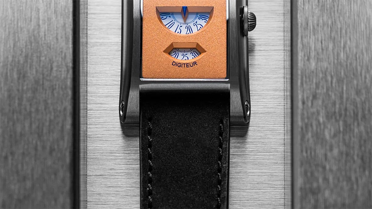 Rectangular watch with orange dial featuring two small windows displaying blue numbers and a black leather strap.