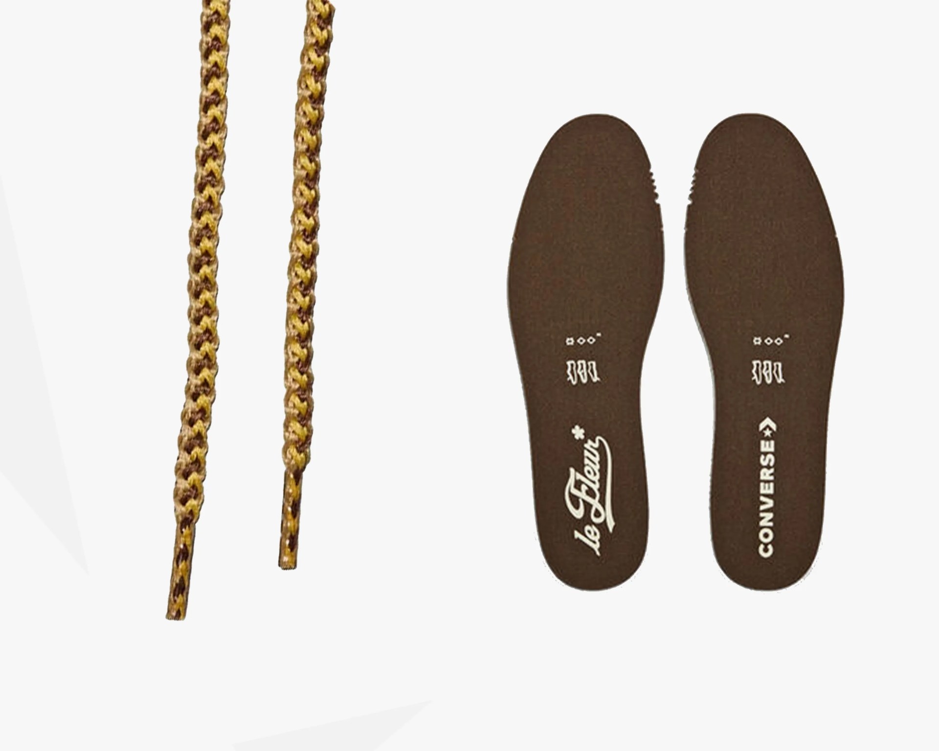 Pair of brown Converse x le Fleur insoles with white logos and two yellow-brown braided shoelaces.
