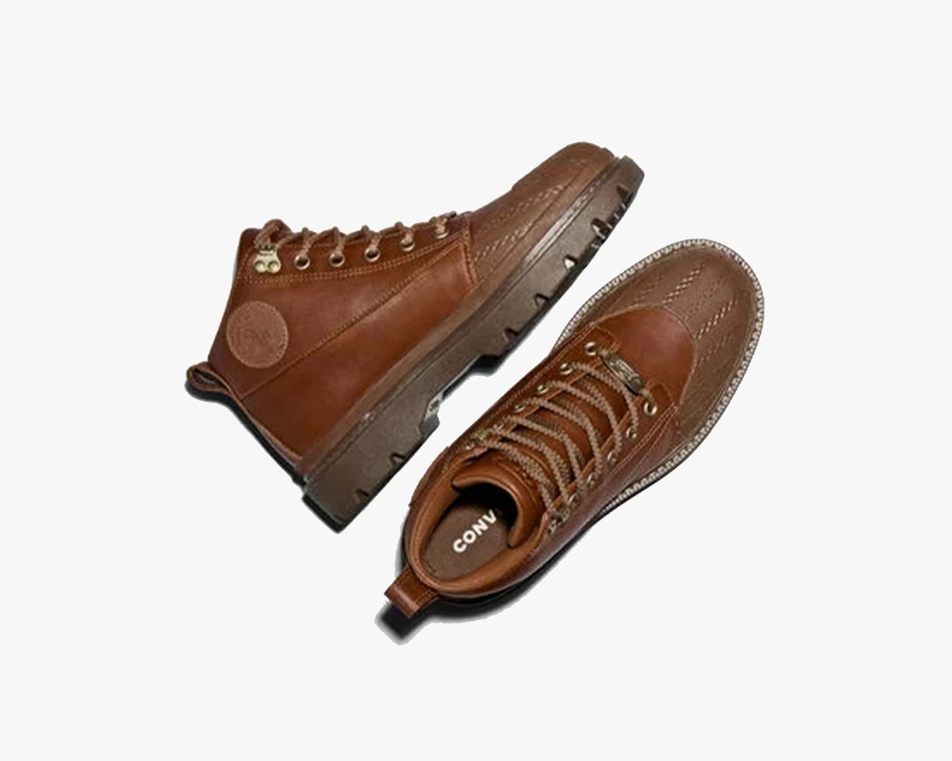 Pair of brown leather high-top boots with rugged soles and metal eyelets on a white background.