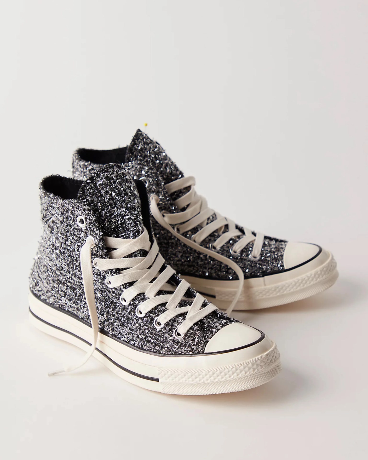 Pair of high-top sneakers with black and white textured knit uppers and white rubber soles and laces.