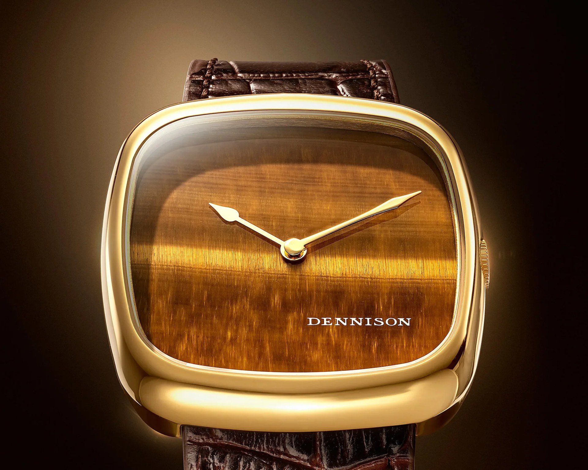 Gold-toned square watch with brown tiger's eye dial and brown leather strap.