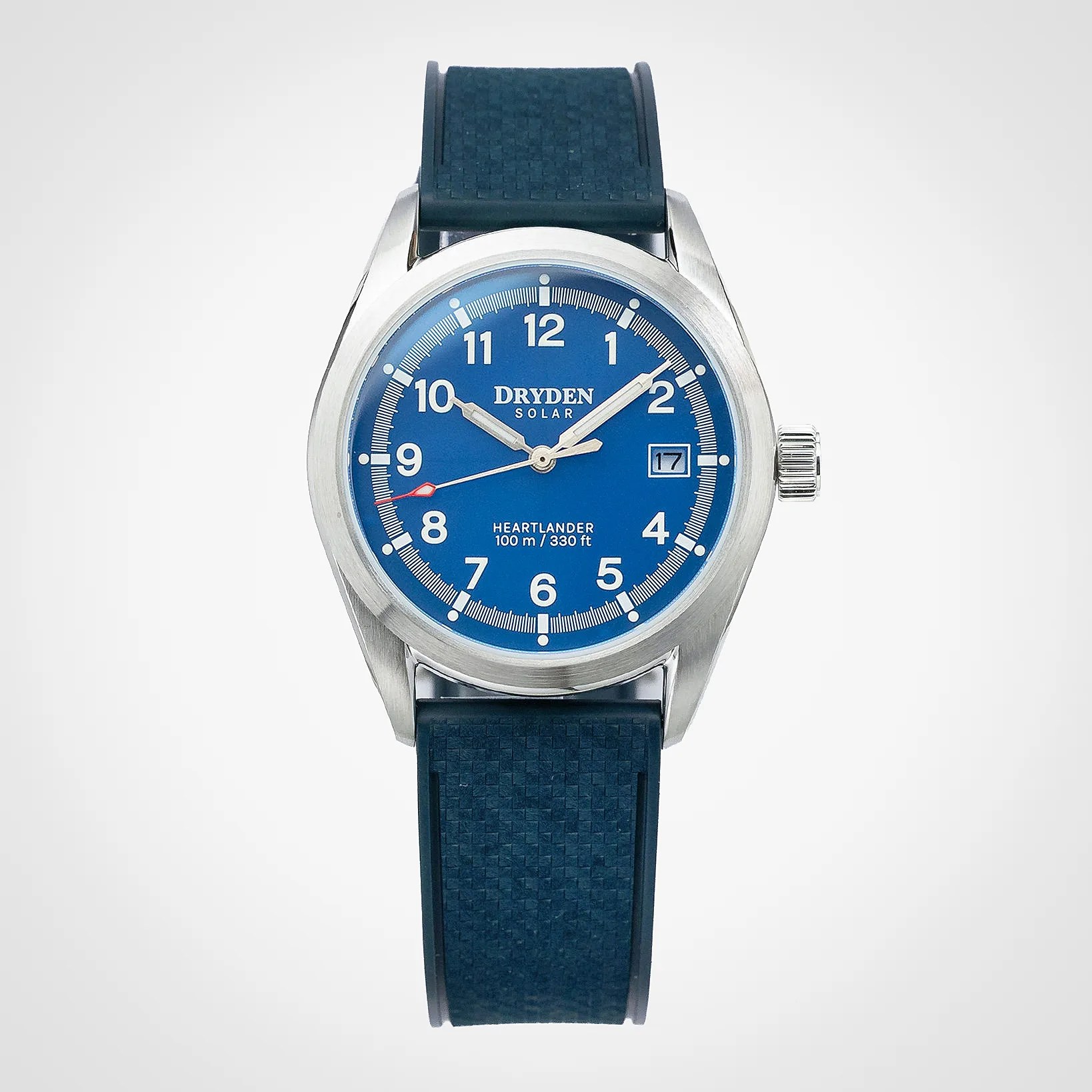 Silver case wristwatch with blue dial, white numerals, date window, and textured blue rubber strap.