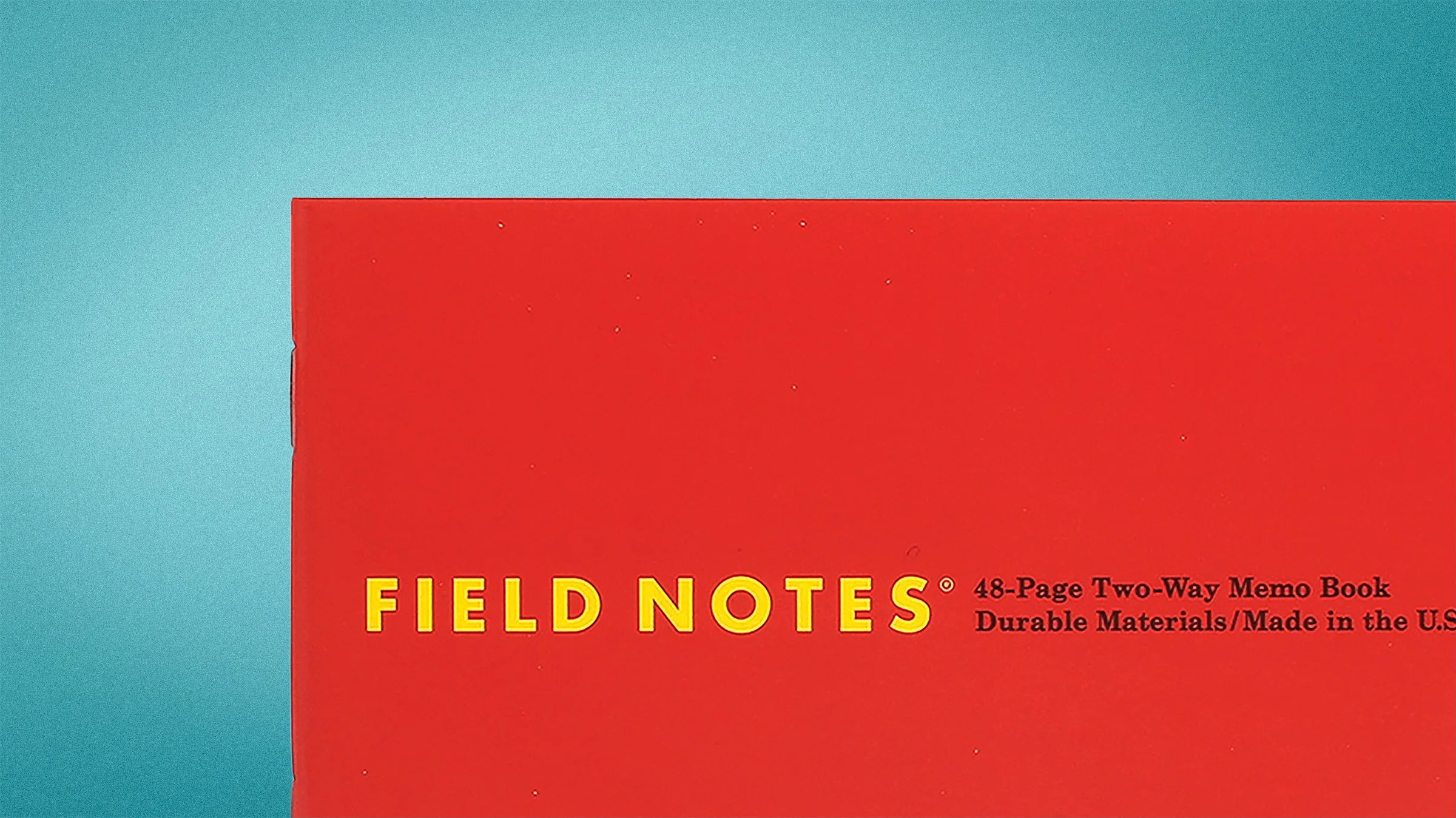 Red Field Notes memo book with yellow and black text on a blue background.