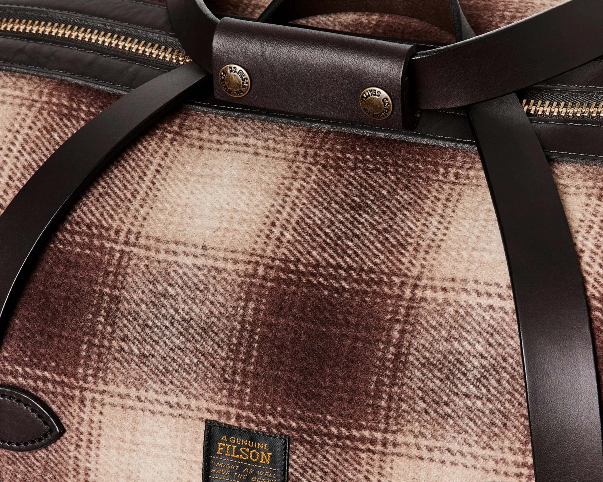 Brown and beige plaid wool bag with dark brown leather straps and brass zipper.
