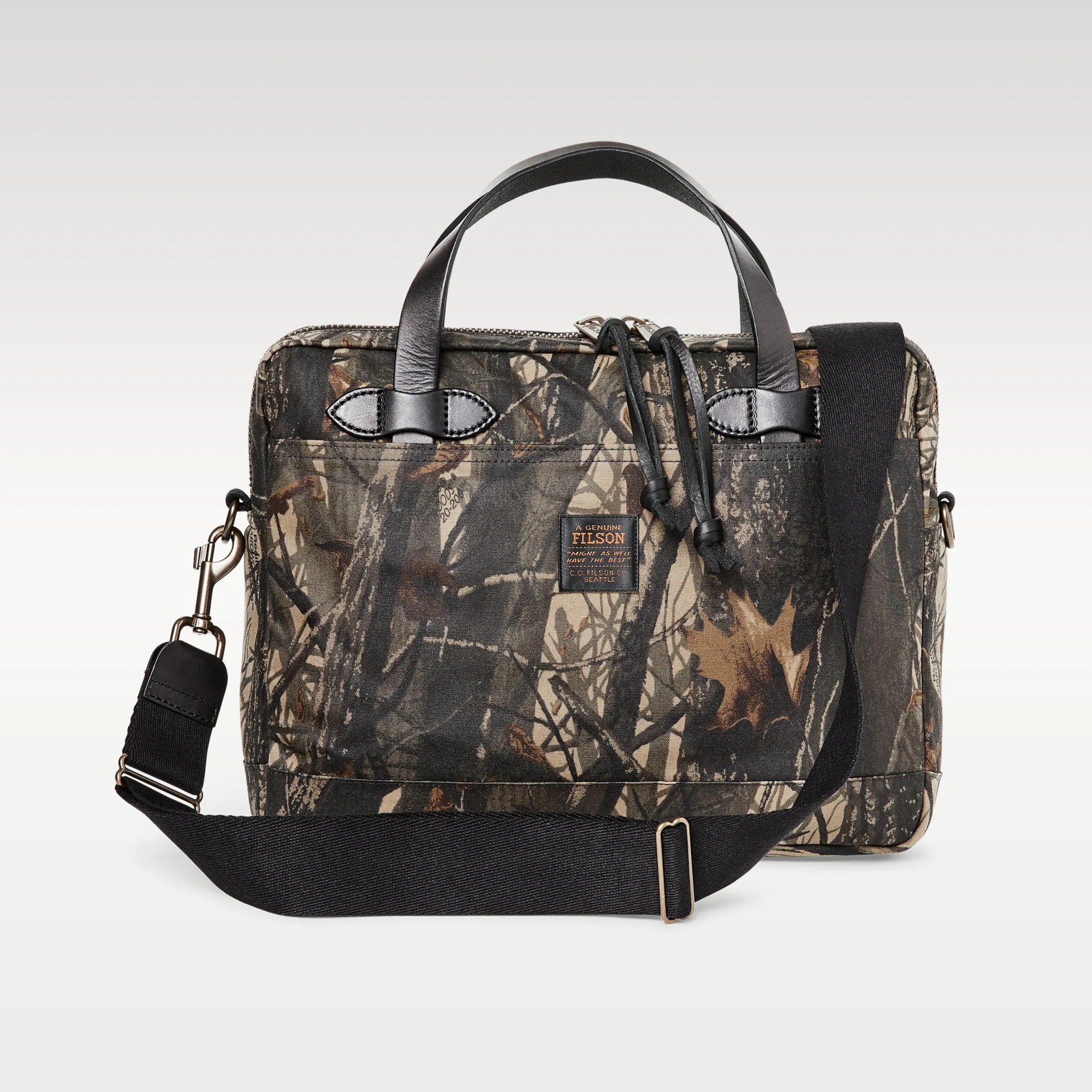 Camouflage-patterned Filson briefcase with black leather handles and adjustable black shoulder strap.
