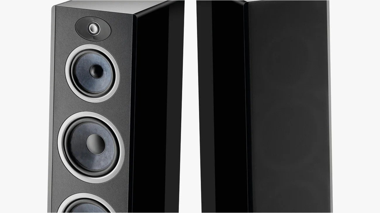 Pair of tall black floor-standing speakers, one with visible drivers and the other with a black grille cover.