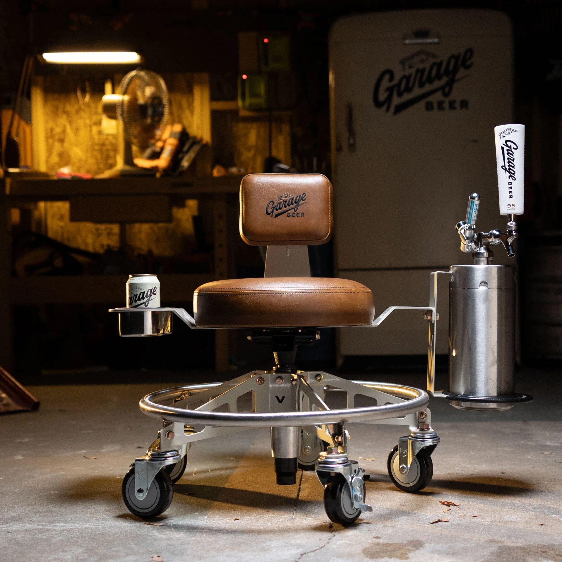 Rolling chair with brown leather seat and backrest labeled "Garage Beer," featuring a cup holder with a can and a mounted beer tap keg.