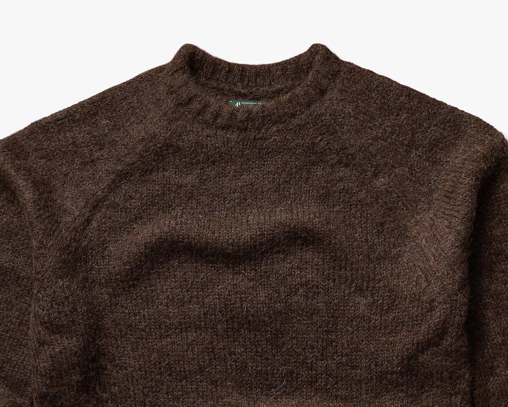 Dark brown fuzzy knit sweater with a ribbed crew neckline.