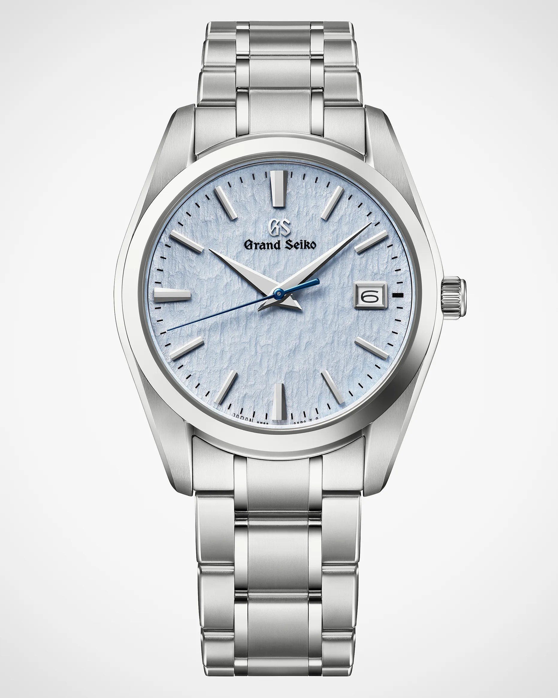 Silver stainless steel Grand Seiko wristwatch with textured light blue dial and date display at 3 o'clock.