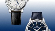 Two Grand Seiko watches with leather straps, one with a white dial and black strap, the other with a blue dial and blue strap.