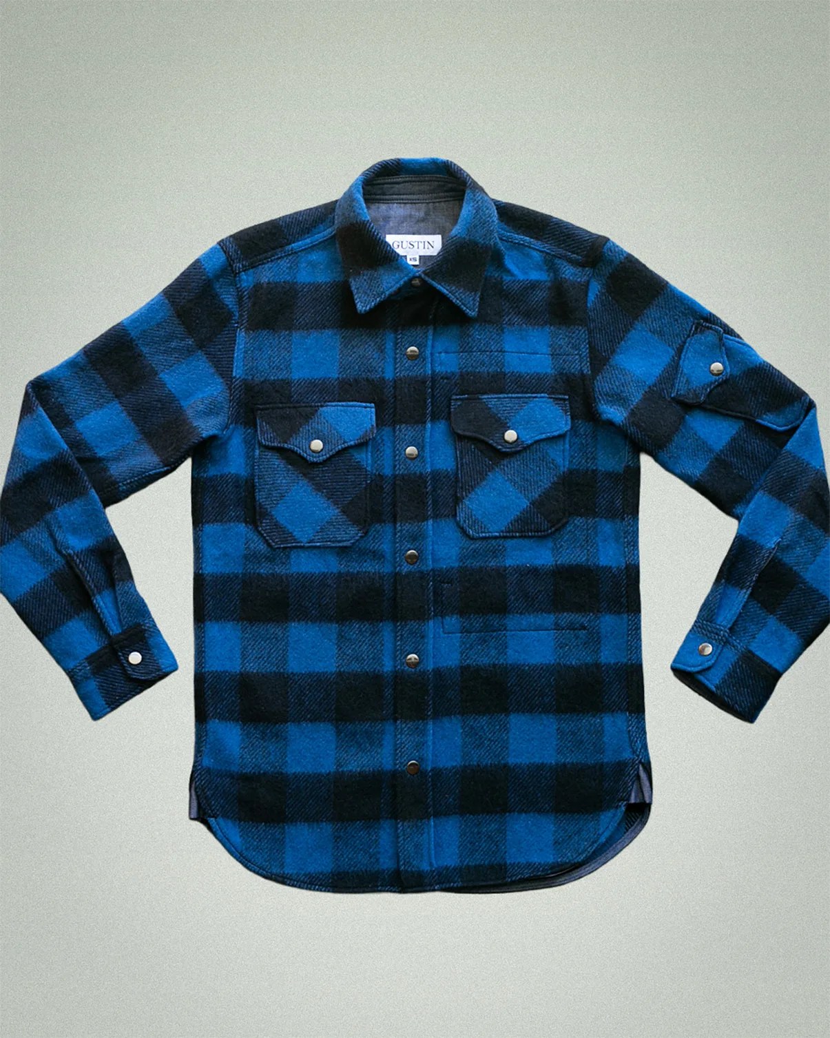 Blue and black checkered flannel shirt with snap buttons and two chest pockets.