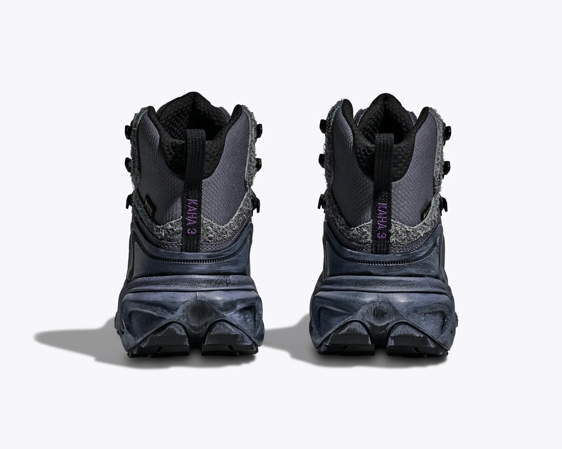 Pair of dark gray hiking boots with textured fabric and thick soles shown from the back.