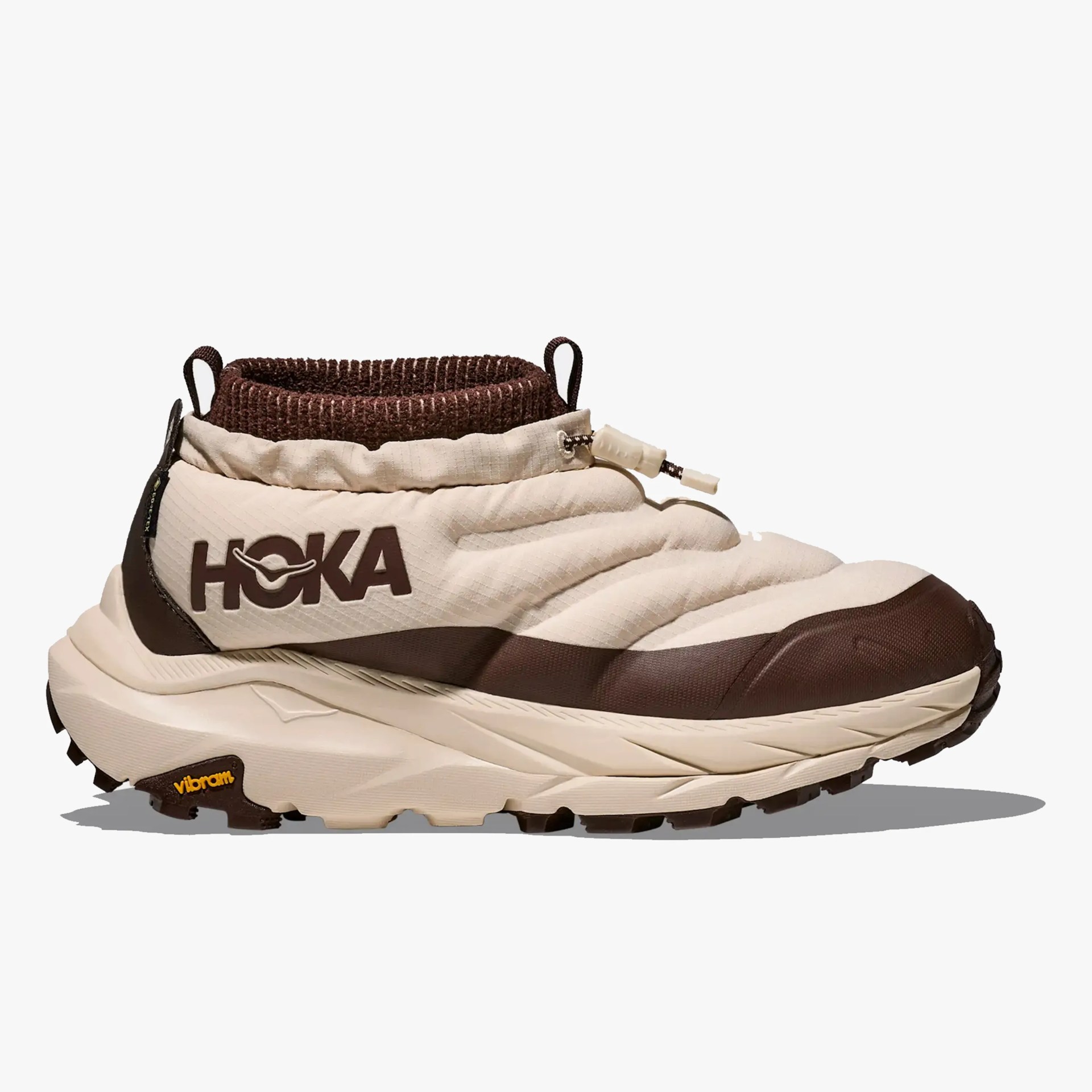 Beige and brown HOKA slip-on sneaker with padded upper and Vibram sole.