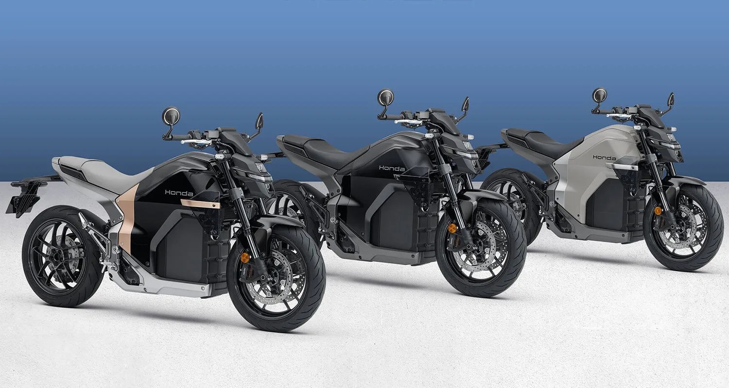 Three Honda electric motorcycles in black, dark gray, and light gray colors lined up on a white surface with a blue gradient background.