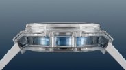 Side view of a transparent watch case with visible internal blue components and white straps.
