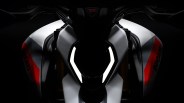 Front view of a Ducati motorcycle with illuminated angular LED headlights and white and red body panels.