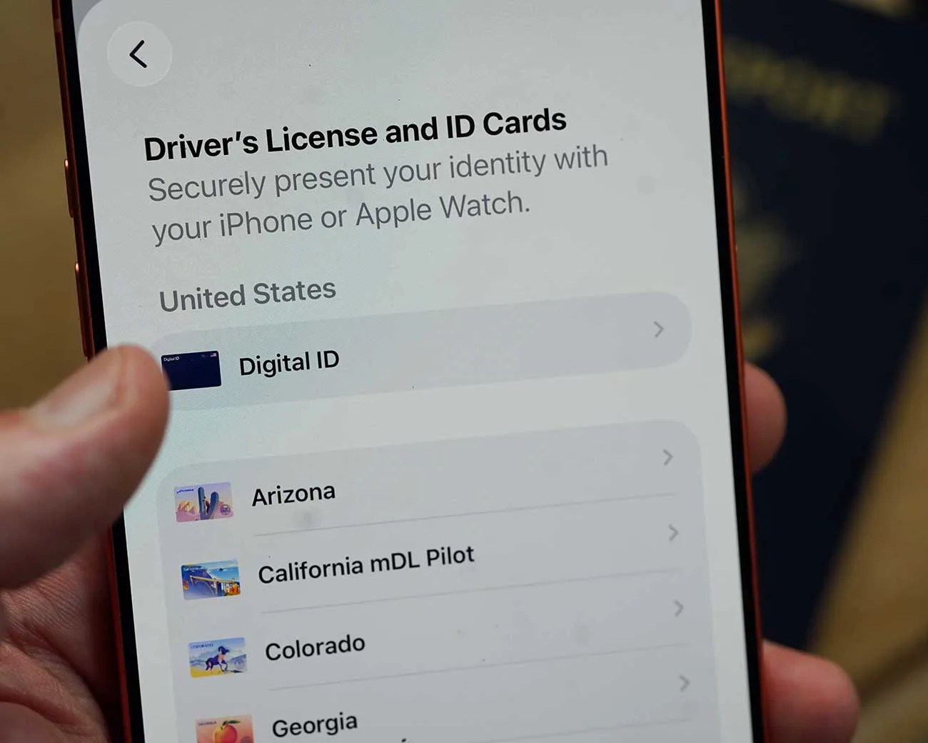 Smartphone screen showing a digital driver's license and ID cards app with options for Arizona, California mDL Pilot, Colorado, and Georgia.