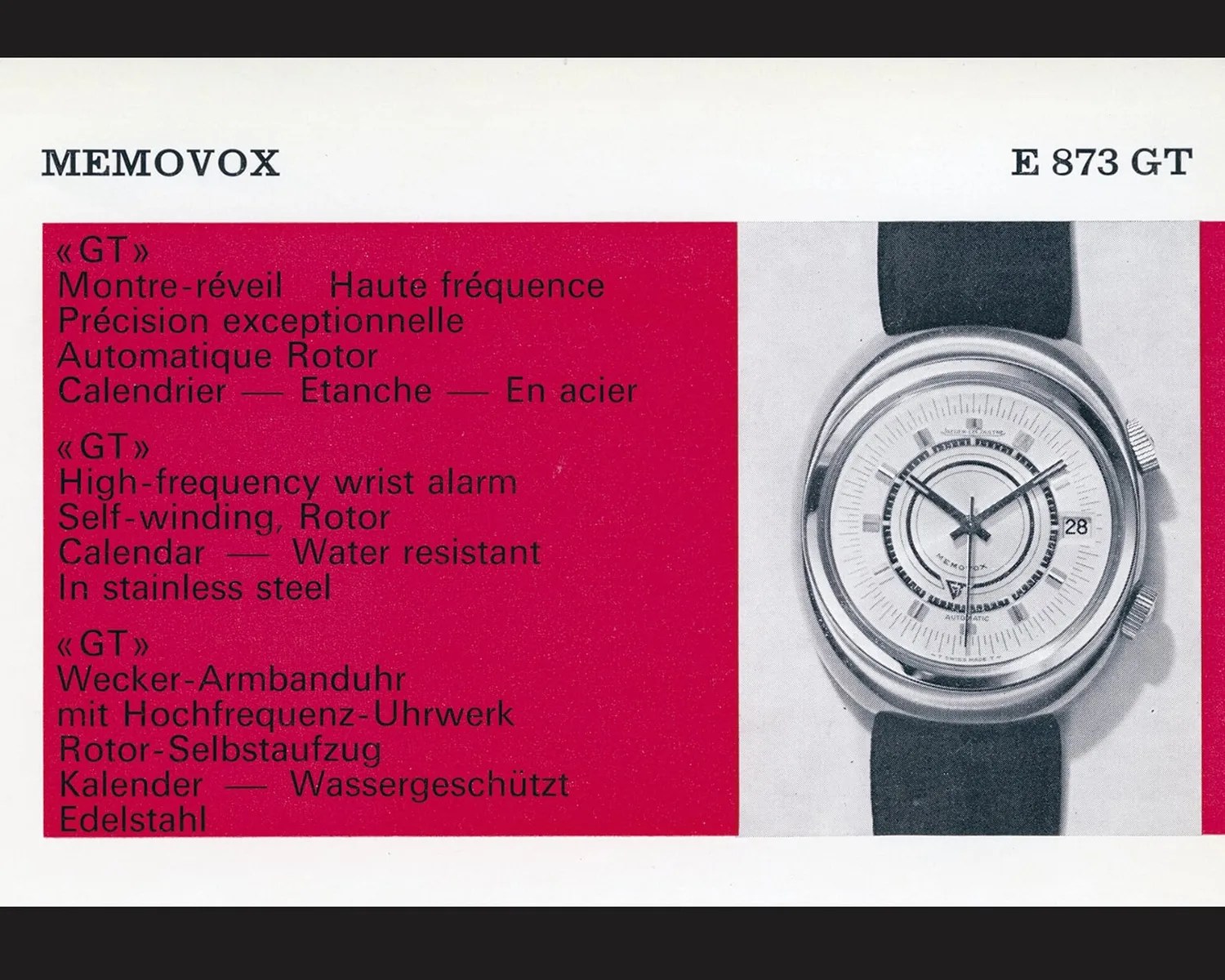 Silver stainless steel Memovox E 873 GT wristwatch with black strap and white dial showing date.