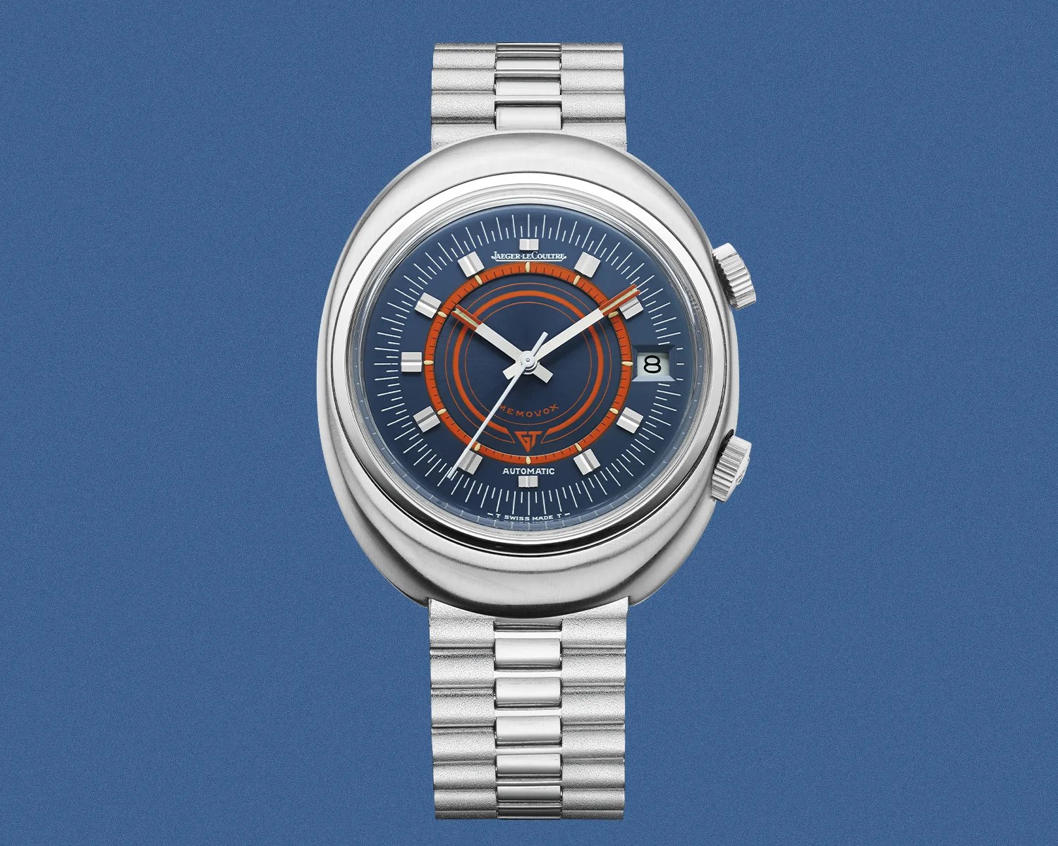 Silver metal wristwatch with blue dial, orange circular accents, and date window at 3 o'clock.