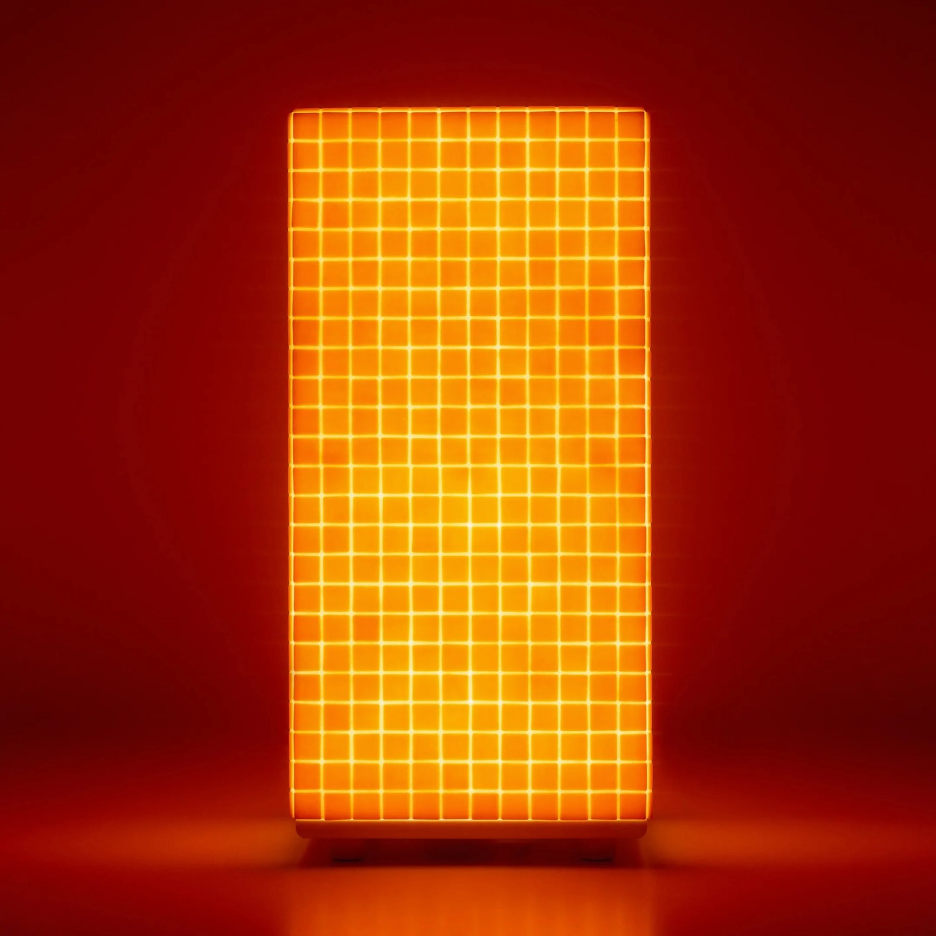 Orange rectangular grid-patterned light panel glowing against a dark red background.