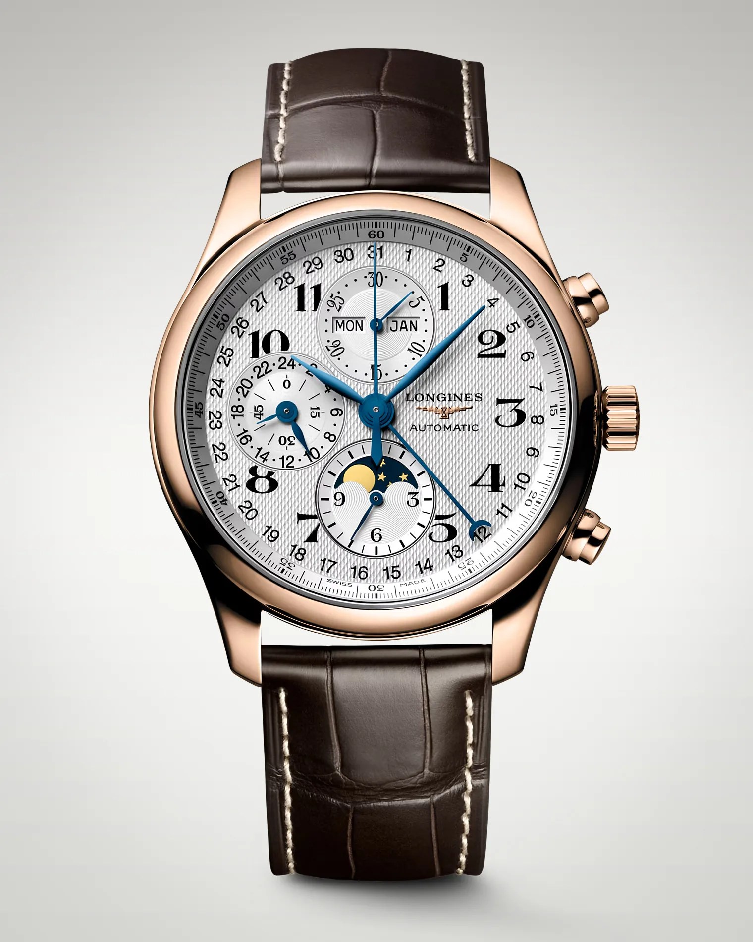 Rose gold Longines automatic wristwatch with white textured dial, blue hands, moon phase, and brown leather strap.
